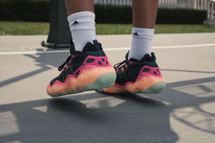 View of Trae Young's black and orange adidas basketball shoes.